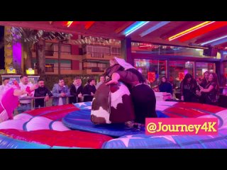 bride and girlfriend riding on a bull in benidorm bull riding 4k